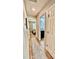 Hallway with wood-look floors leads to bedroom and bathroom with dark hardware and doors at 13486 English Sparrow Rd, Weeki Wachee, FL 34614