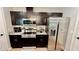 Modern kitchen featuring stainless steel appliances, granite countertops, and dark wood cabinetry at 13486 English Sparrow Rd, Weeki Wachee, FL 34614