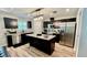 Modern kitchen boasts dark cabinets, stainless steel appliances, and a center island at 13486 English Sparrow Rd, Weeki Wachee, FL 34614