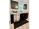 A stylish wet bar provides more cabinets, stainless steel dishwasher and sink under bright window at 13486 English Sparrow Rd, Weeki Wachee, FL 34614
