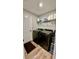 Laundry room with gray washer and dryer, tile floors, and white door at 13486 English Sparrow Rd, Weeki Wachee, FL 34614