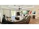 Spacious living room features a large sectional sofa, ceiling fan, and sliding glass doors to the backyard at 13486 English Sparrow Rd, Weeki Wachee, FL 34614