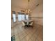 Cozy breakfast nook with tiled floors, bright chandelier and lots of natural light at 1695 Stable Trl, Palm Harbor, FL 34685