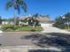 Charming single-story home with mature landscaping and a two-car garage at 1695 Stable Trl, Palm Harbor, FL 34685