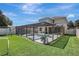 Large, fenced backyard with a screened pool area, providing privacy and outdoor enjoyment at 17419 New Cross Cir, Lithia, FL 33547