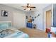 Bedroom features carpeted floors, ceiling fan and closet doors, and a twin bed with colorful bedding at 17419 New Cross Cir, Lithia, FL 33547