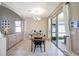 Dining area with tile floors, modern lighting, and sliding glass doors leading to the patio at 17419 New Cross Cir, Lithia, FL 33547