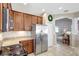 Well-equipped kitchen with stainless steel refrigerator, gas range, and granite counters at 17419 New Cross Cir, Lithia, FL 33547