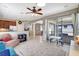 Bright living room featuring a ceiling fan, tile floors, and sliding doors to a screened lanai at 17419 New Cross Cir, Lithia, FL 33547