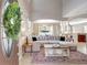 Bright living room with high ceilings, a large sectional, and view of the dining room at 17419 New Cross Cir, Lithia, FL 33547
