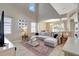 Spacious living area featuring high ceilings, large windows, neutral tones, and a decorative rug at 17419 New Cross Cir, Lithia, FL 33547