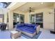 Relaxing covered patio featuring outdoor seating and views of the backyard at 17419 New Cross Cir, Lithia, FL 33547