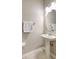 Powder Room featuring pedestal sink with framed oval mirror and tiled floors at 17419 New Cross Cir, Lithia, FL 33547