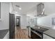 Bright kitchen with stainless steel appliances and modern design flowing into the living area at 1844 Seton Dr, Clearwater, FL 33763