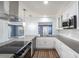 Open kitchen featuring stainless appliances, modern cabinets, and an island cooktop at 1844 Seton Dr, Clearwater, FL 33763