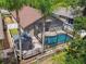 Aerial view of the home with pool, deck, screened enclosure, and backyard at 2719 Brookville Dr, Valrico, FL 33596
