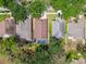 Aerial view highlighting a backyard pool in a neighborhood surrounded by lush greenery and trees at 2719 Brookville Dr, Valrico, FL 33596