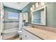 Bathroom features granite countertops, gray tiling, and modern vanity at 2719 Brookville Dr, Valrico, FL 33596
