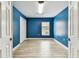 Blue bedroom with wood-look floors and natural light at 2719 Brookville Dr, Valrico, FL 33596