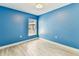 Bright bedroom featuring wood-look tile flooring and a window with natural light at 2719 Brookville Dr, Valrico, FL 33596
