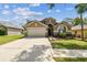 Charming single Gathering home with a well-manicured lawn, two car garage and mature landscaping at 2719 Brookville Dr, Valrico, FL 33596