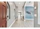 Inviting foyer with wood-look tile flooring and arched doorway at 2719 Brookville Dr, Valrico, FL 33596