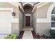 A welcoming front entrance with a brick path leading to a mahogany-colored front door at 2719 Brookville Dr, Valrico, FL 33596