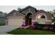 Charming home exterior with well-maintained landscaping and an attached garage at 2719 Brookville Dr, Valrico, FL 33596