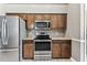 Kitchen featuring stainless steel appliances and wood cabinetry at 2719 Brookville Dr, Valrico, FL 33596