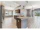 Open-concept kitchen featuring stainless steel appliances, granite countertops, and tile flooring at 2719 Brookville Dr, Valrico, FL 33596
