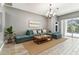 Comfortable living room with a large sectional sofa, area rug, and sliding door to the patio at 2719 Brookville Dr, Valrico, FL 33596