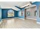 Bright living room with large window and wood-look tile flooring at 2719 Brookville Dr, Valrico, FL 33596