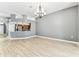 Open living room with wood-look tile flooring flowing into the kitchen with stainless appliances at 2719 Brookville Dr, Valrico, FL 33596