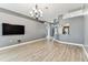 Bright living room with wood-look tile flooring, adjacent to kitchen and bedrooms at 2719 Brookville Dr, Valrico, FL 33596