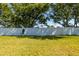 Lush green backyard with a tall white fence providing ample privacy and security for outdoor enjoyment at 309 Countryside Key Blvd, Oldsmar, FL 34677