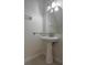 Clean bathroom with pedestal sink and arched mirror at 309 Countryside Key Blvd, Oldsmar, FL 34677