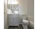 Bright bathroom with a gray vanity, toilet, and subway-tiled shower, offering a clean and modern look at 309 Countryside Key Blvd, Oldsmar, FL 34677