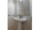 Clean bathroom with pedestal sink and arched mirror at 309 Countryside Key Blvd, Oldsmar, FL 34677