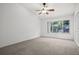 Bright bedroom featuring a large window and neutral carpet, creating a serene and inviting space at 309 Countryside Key Blvd, Oldsmar, FL 34677