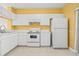 Functional kitchen with white cabinets and appliances, providing a clean and efficient cooking space at 309 Countryside Key Blvd, Oldsmar, FL 34677