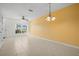Spacious living area with tile flooring, ceiling fan, and large window offering natural light at 309 Countryside Key Blvd, Oldsmar, FL 34677