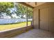 Enclosed patio overlooking a well maintained yard with a white fence at 309 Countryside Key Blvd, Oldsmar, FL 34677