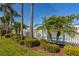 Community pool area featuring a white fence and lush landscaping, perfect for relaxation and recreation at 309 Countryside Key Blvd, Oldsmar, FL 34677