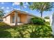 This backyard features a covered patio, green lawn, and mature landscaping at 31434 Shaker Cir, Wesley Chapel, FL 33543