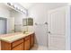 Bright bathroom featuring a large mirror and a vanity at 31434 Shaker Cir, Wesley Chapel, FL 33543