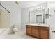 Bathroom with a tub and vanity with matching mirror and tile flooring at 31434 Shaker Cir, Wesley Chapel, FL 33543