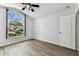 Bedroom view showcasing the wood floors and large front window at 31434 Shaker Cir, Wesley Chapel, FL 33543