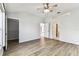 Bedroom featuring wood-look floors, neutral paint, a ceiling fan, and ensuite bathroom and walk-in closet at 31434 Shaker Cir, Wesley Chapel, FL 33543