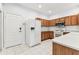 Bright kitchen with white appliances, light countertops, and wood cabinets at 31434 Shaker Cir, Wesley Chapel, FL 33543