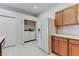Bright kitchen adjoins a laundry closet with washer and dryer at 31434 Shaker Cir, Wesley Chapel, FL 33543